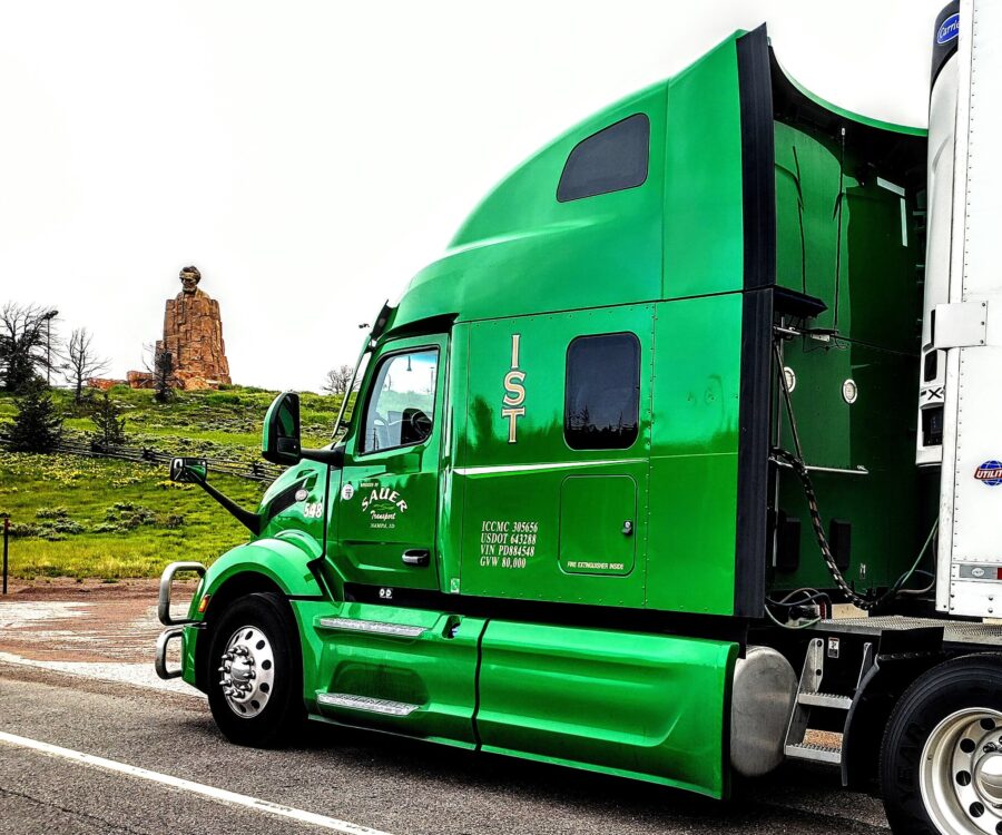 A green semi freight truck parked at the Lincoln Memorial Rest Area