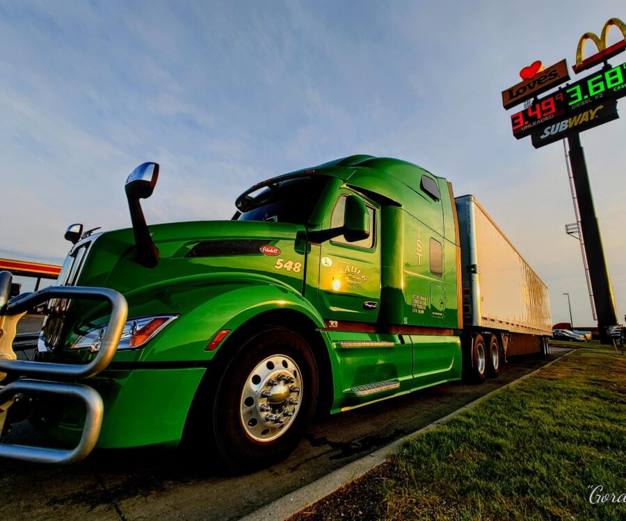 A green freight transport truck parked at truck stop in North Platte, Nebraska